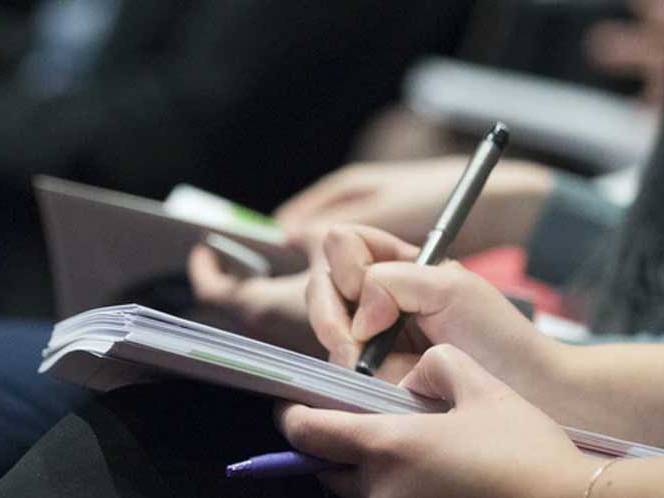 Student taking notes in a journal